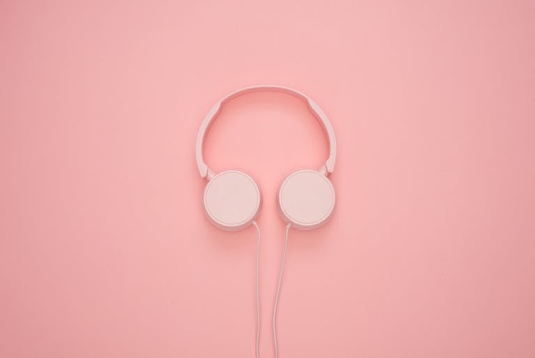 Aesthetic pink headphones on a pastel background, perfect for a modern and stylish look.
